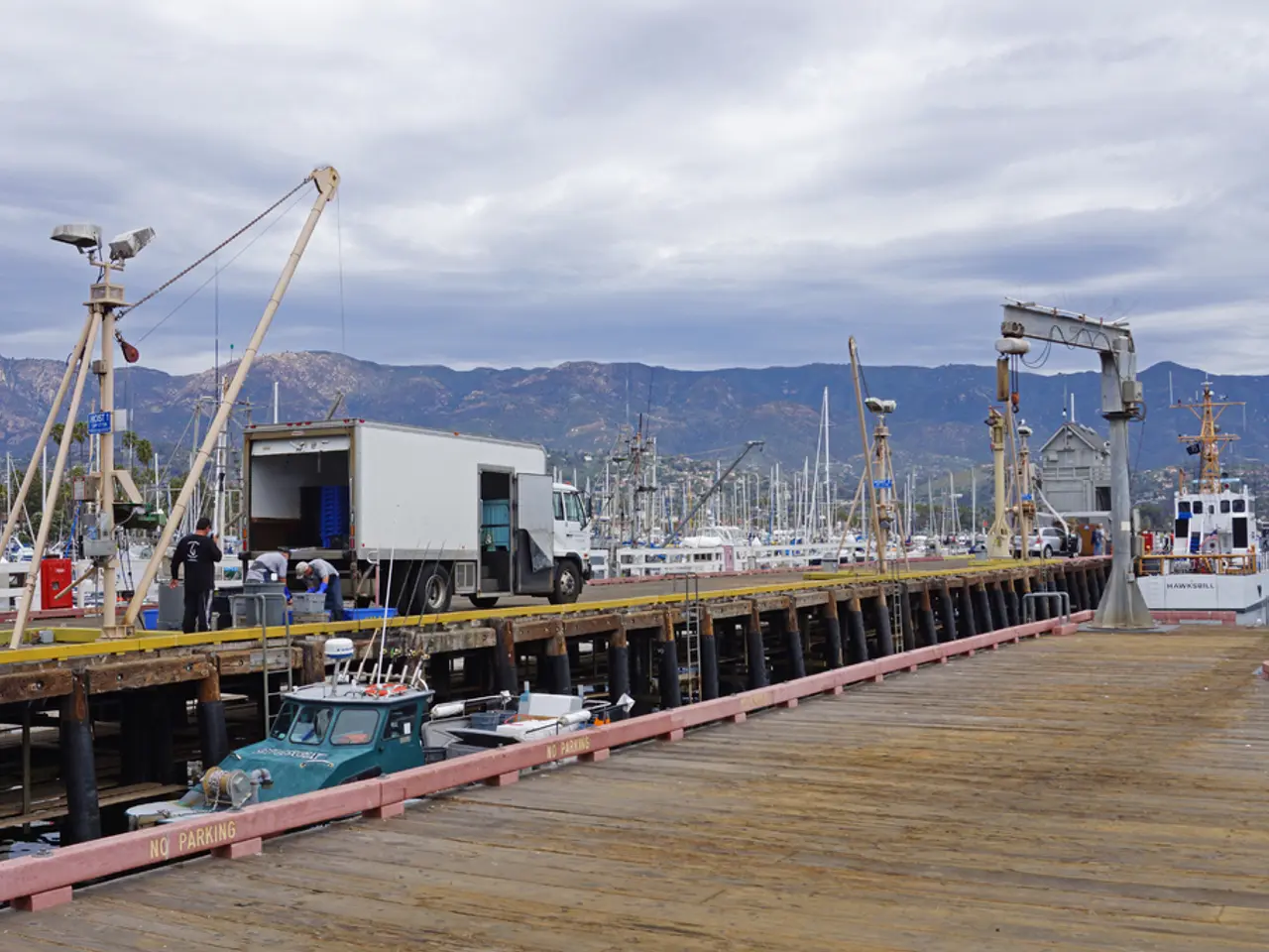 This is looking like a bridge. Here there is a truck. Few people are here. In the background on the...