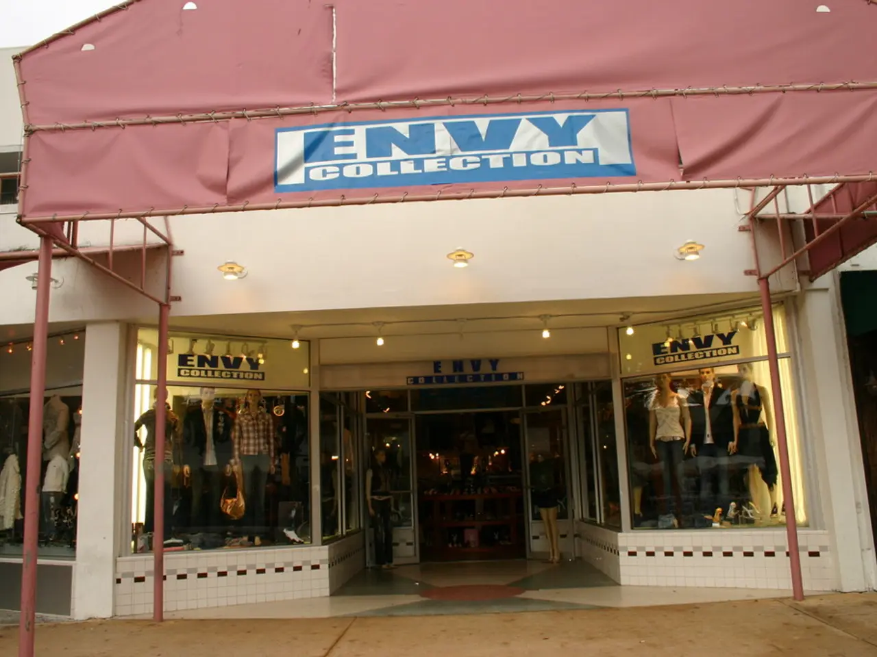 In this image there is a building as we can see at middle of this image and there is a board with...