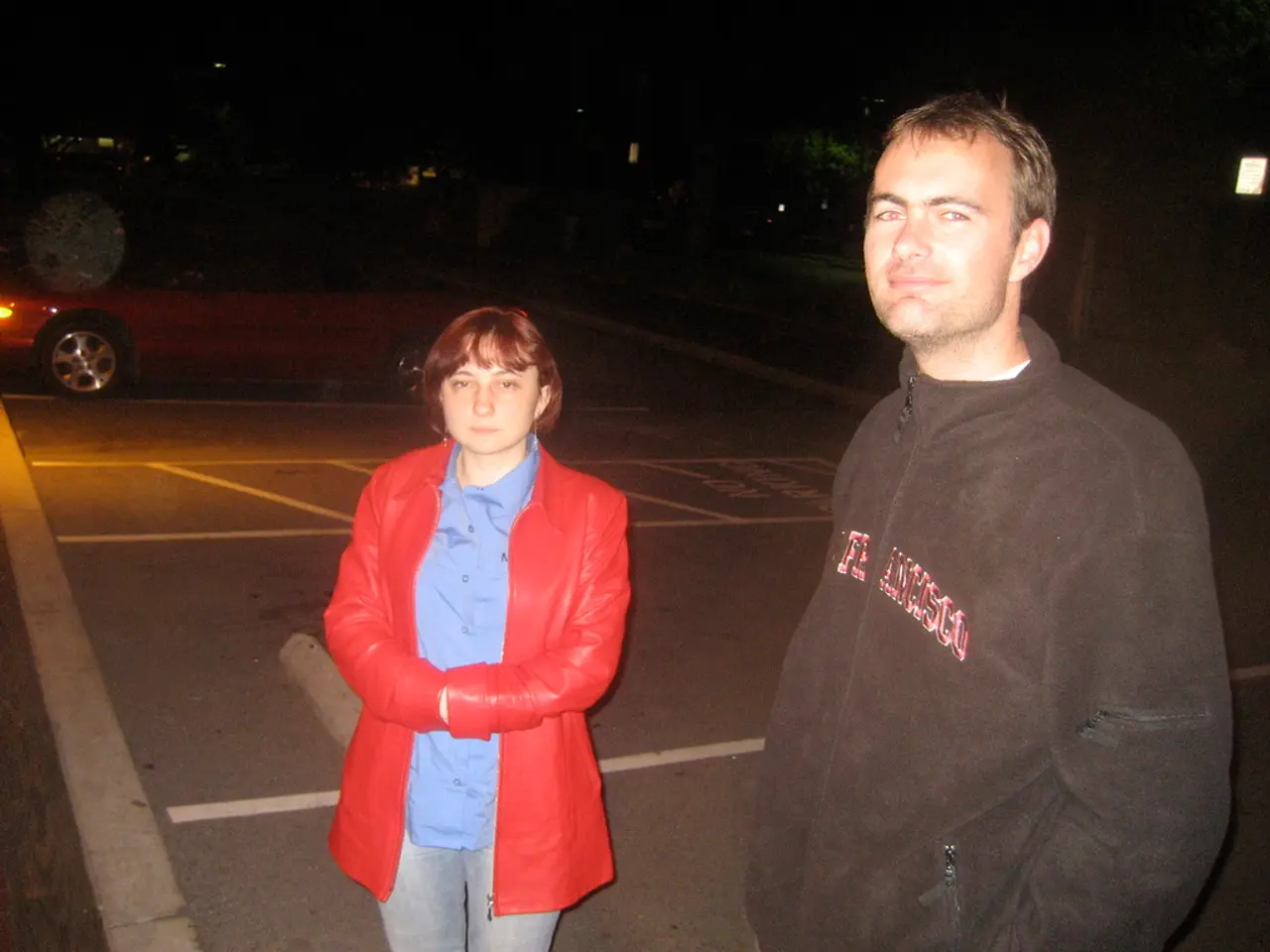 This image is taken during the night time. In this image we can see a man and a woman standing. In...