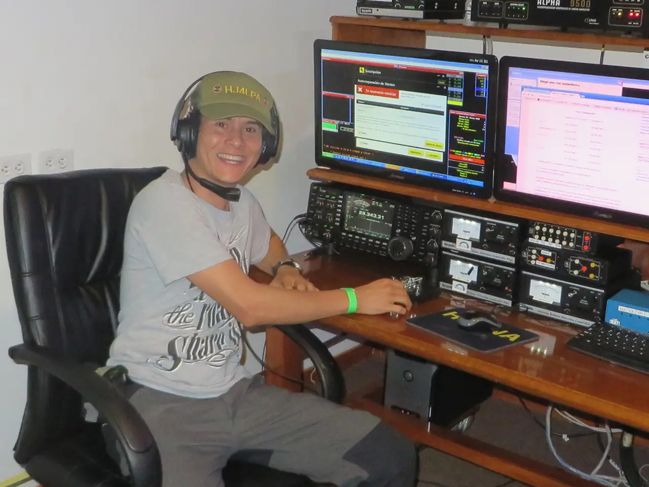 In this picture there is a man who is wearing a grey shirt and is wearing a headphone and a cap on...