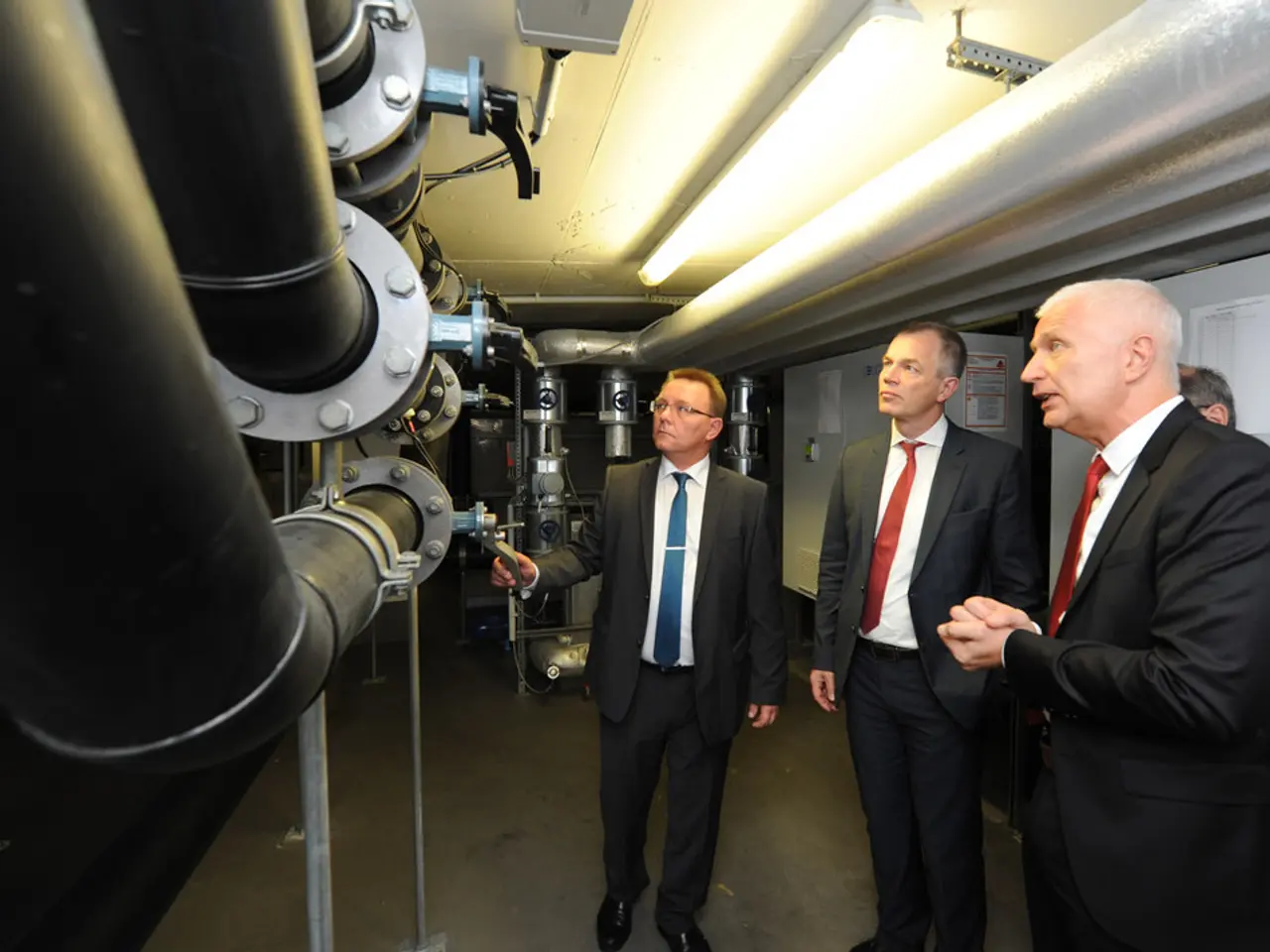 In this picture I can observe four members on the right side. Three of them are wearing coats. On...