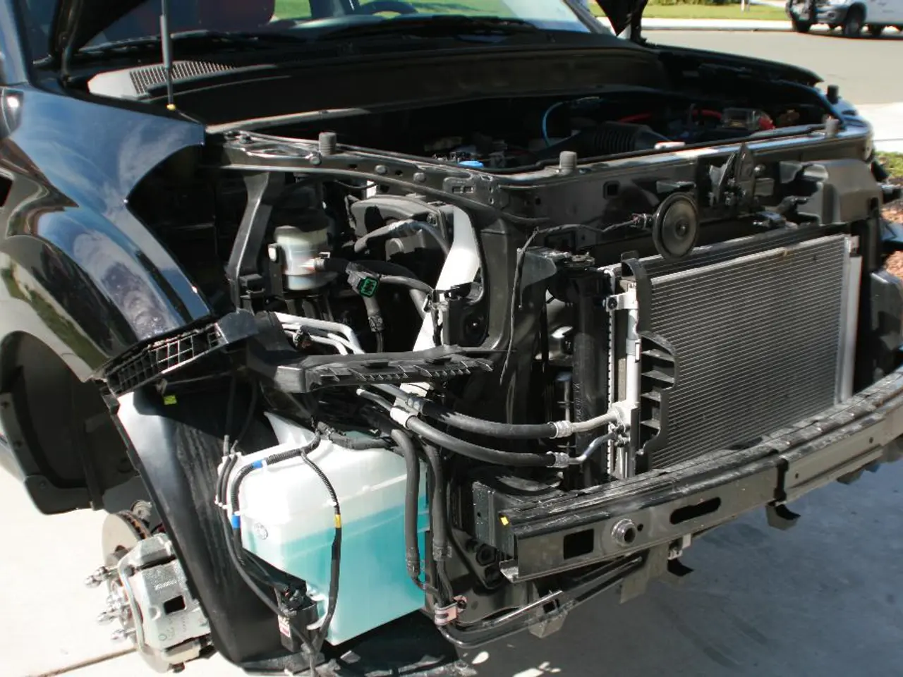 In the image there is a car with an engine is open. At the top right corner of the image there is a...