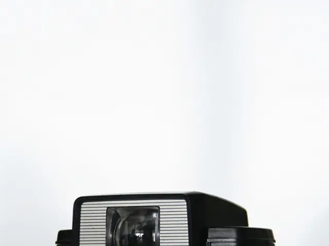 In this picture we can see a camera on the surface.