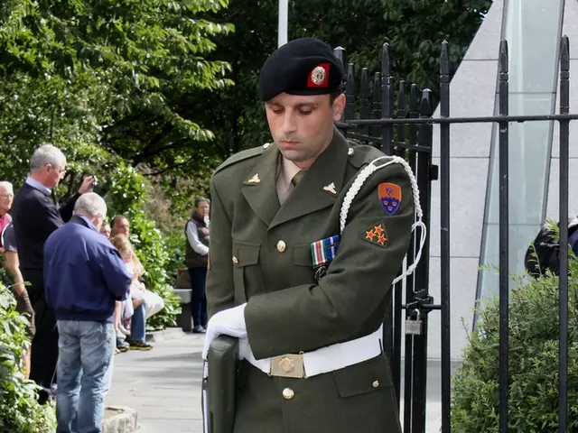 In this image we can see a person wearing uniform and holding gun in his hands and in the...