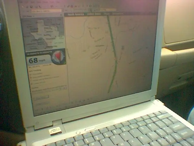 In this image I can see the laptop and there is a cream color background.