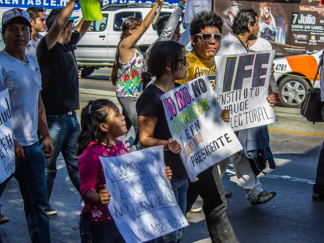 In the picture we can see some people and children are walking holding some boards with some...