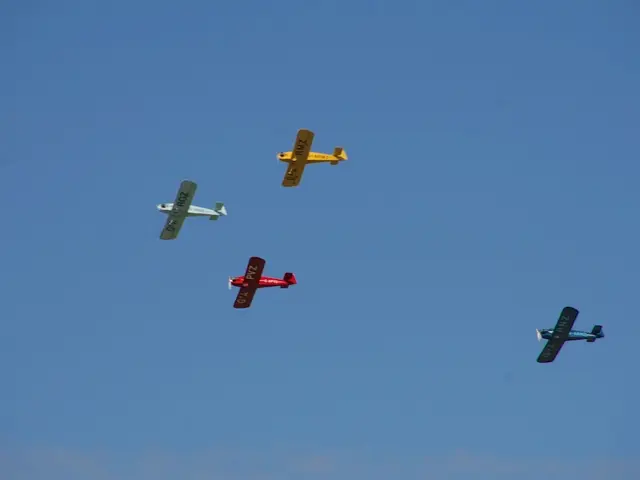 In this image, there are some aeroplanes in the air and there is a blue color sky.