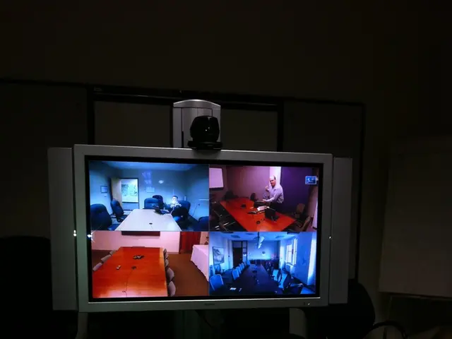 In this image I can see a screen , in the screen I can see images , in front of the screen I can...