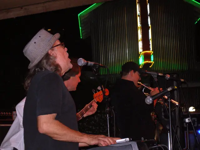 In this image we can see few people playing musical instruments and there are few mics in front of...